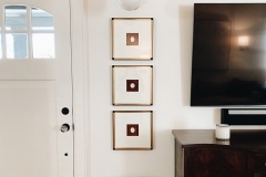 three stacked pieces of art